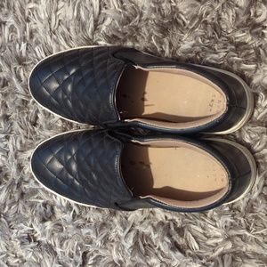 Black quilted slip ons